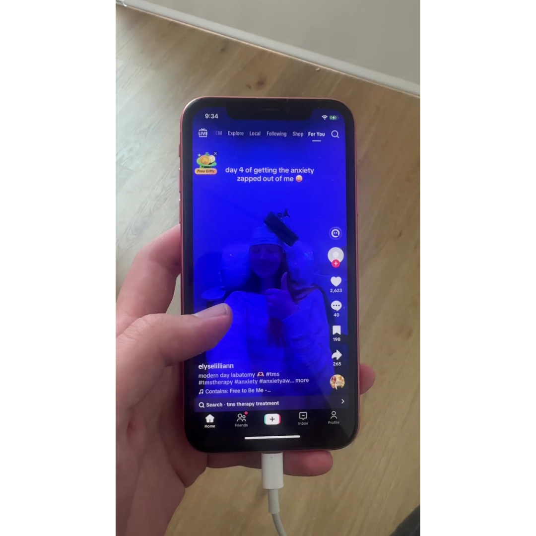 Scrolling through a TikTok For You feed full of health anxiety content — a video titled 'day 4 of getting the anxiety zapped out of me' from @elyselilliann about TMS therapy.